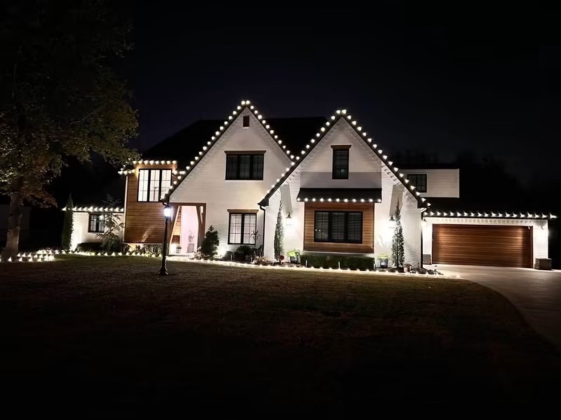 Warm white roofline lighting on a white home
